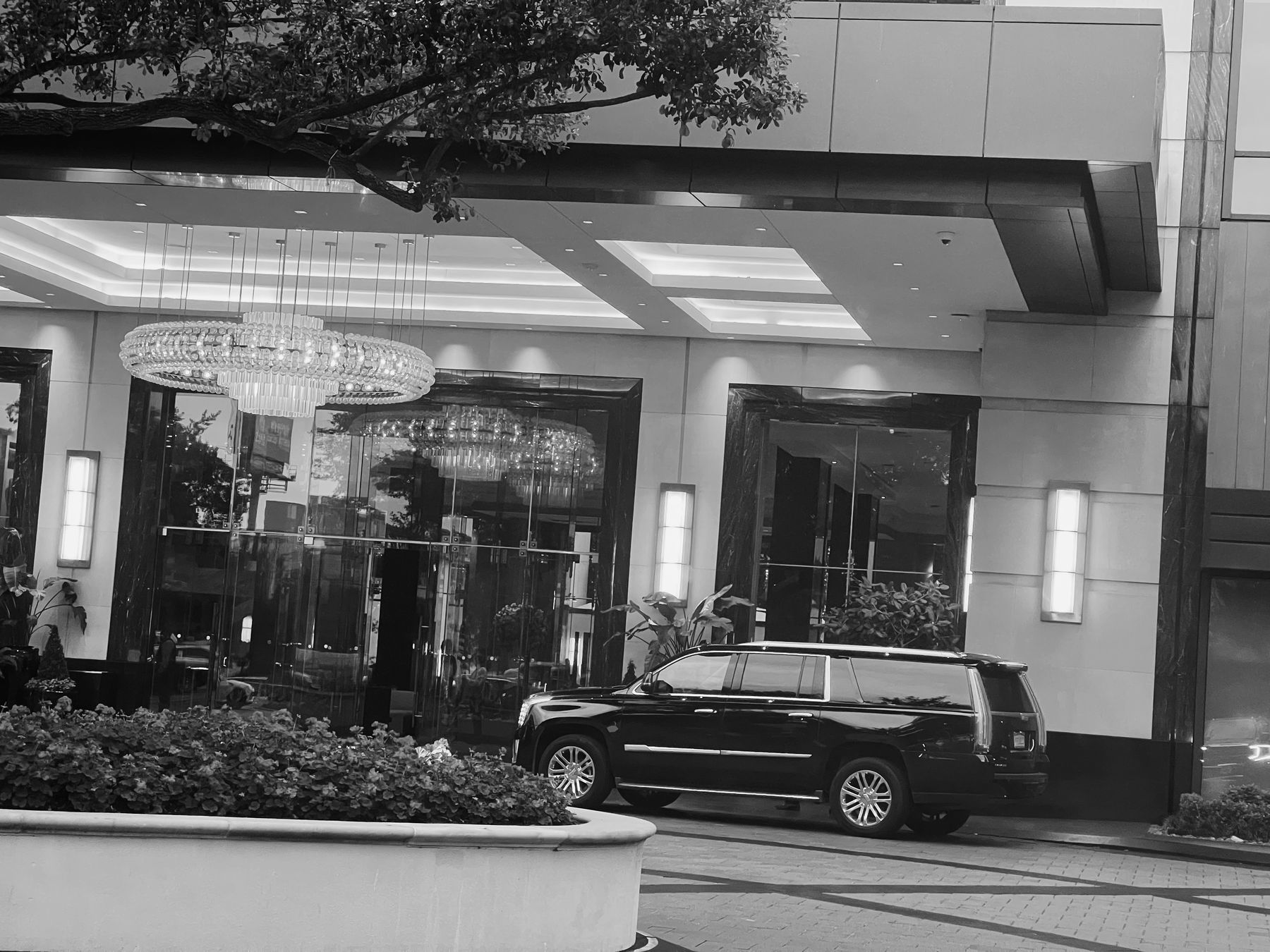 TMR Escalade at a hotel entrance